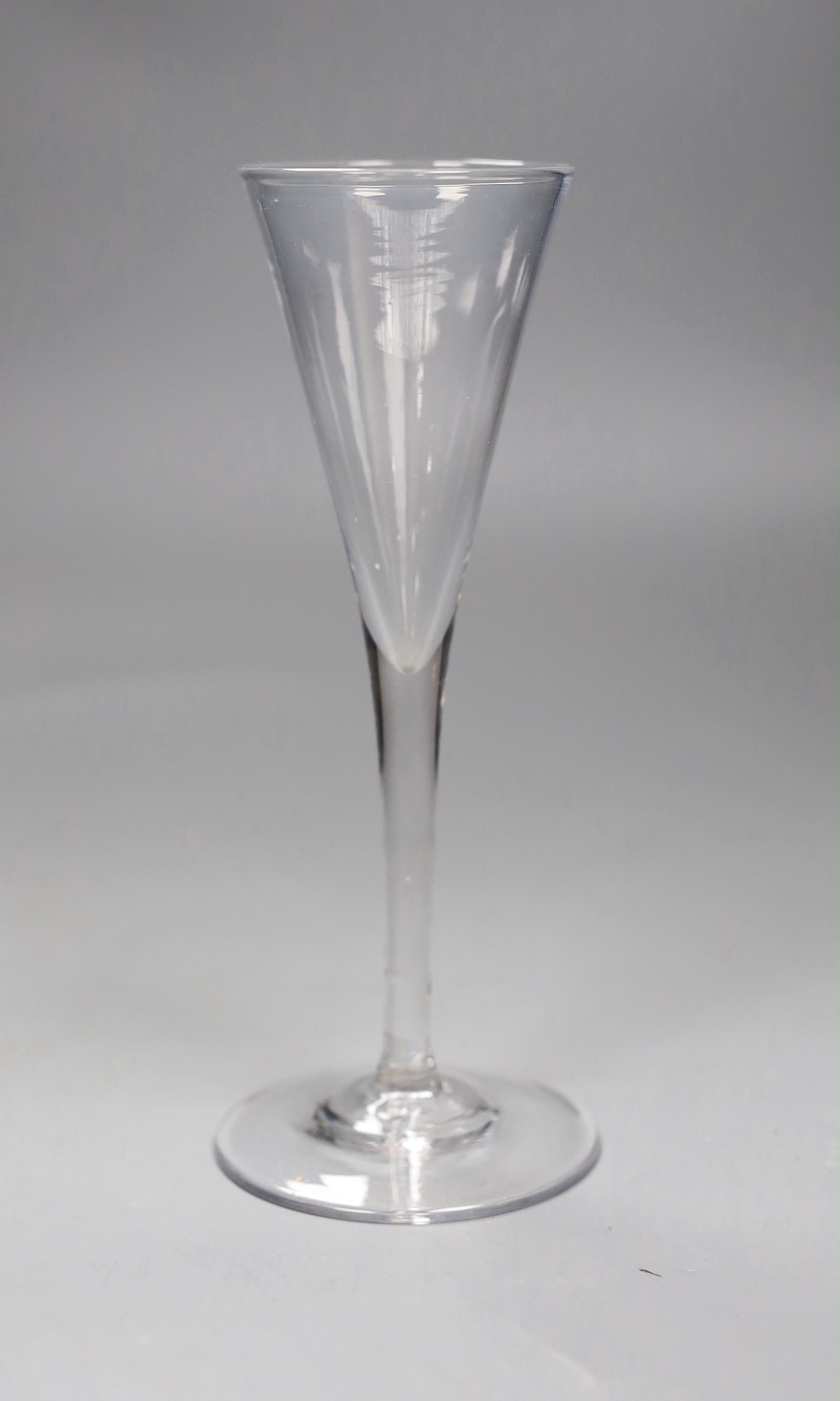 An 18th century toasting glass, 19cms high